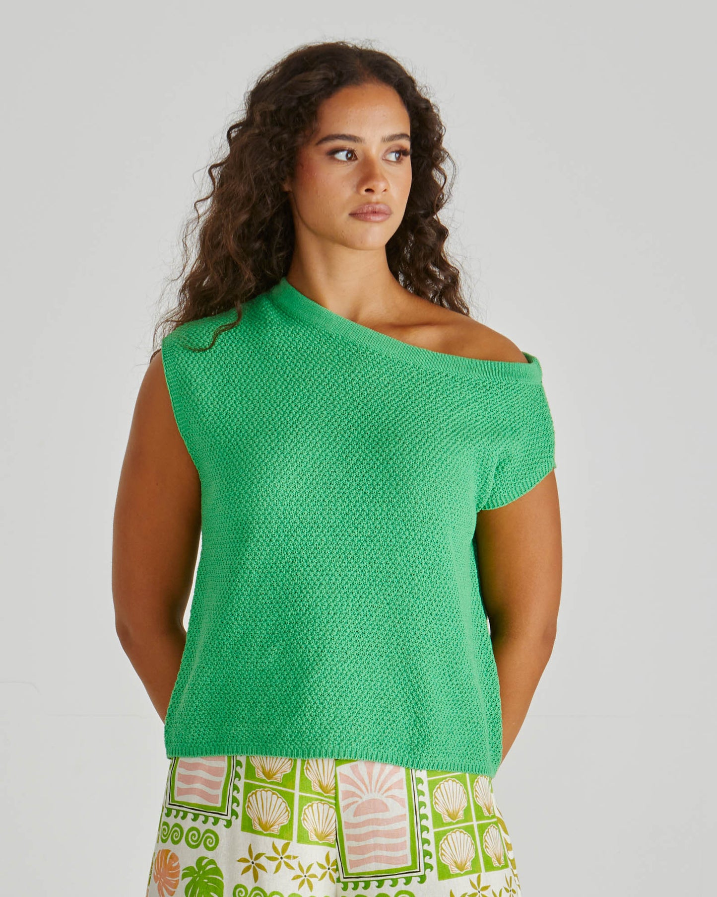 Lady wearing the SASS Jaci Knit Top in green with asymmetrical neckline and moss knit stitch detail. Available at Loloma Living, Tamborine Mountain - SASS Stockist.