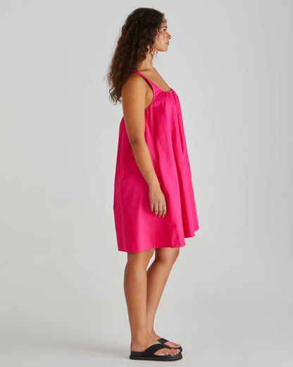 SASS Ellis Mini Dress in hot pink with scalloped wide hem and side pockets. Side view with wide straps. Available at Loloma Living.