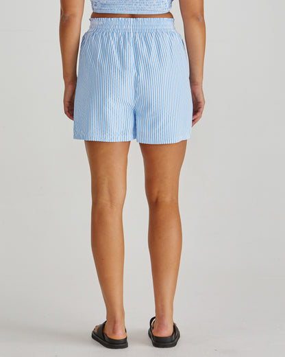 Back view of Lady wearing the SASS Alani Short in blue white stripe seersucker with elastic waist, drawcord and side pockets. Available at Loloma Living Tamborine Mountain - stockist of SASS and Betty Basics.
