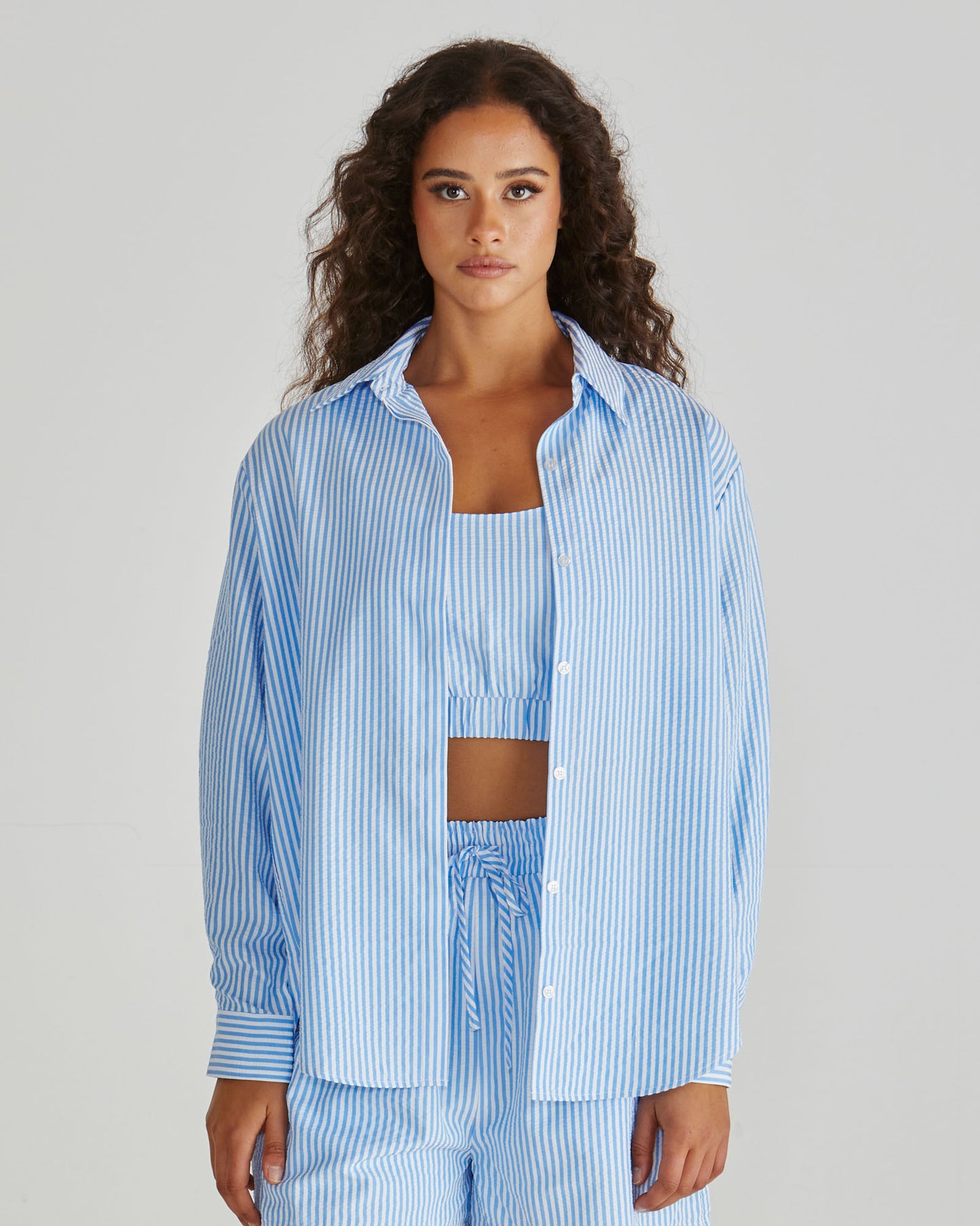 Lady wearing the SASS Alani Shirt in Blue White Stripe seersucker with concealed placket and dropped shoulder. Available at Loloma Living, Tamborine Mountain - stockist of SASS and Betty Basics.