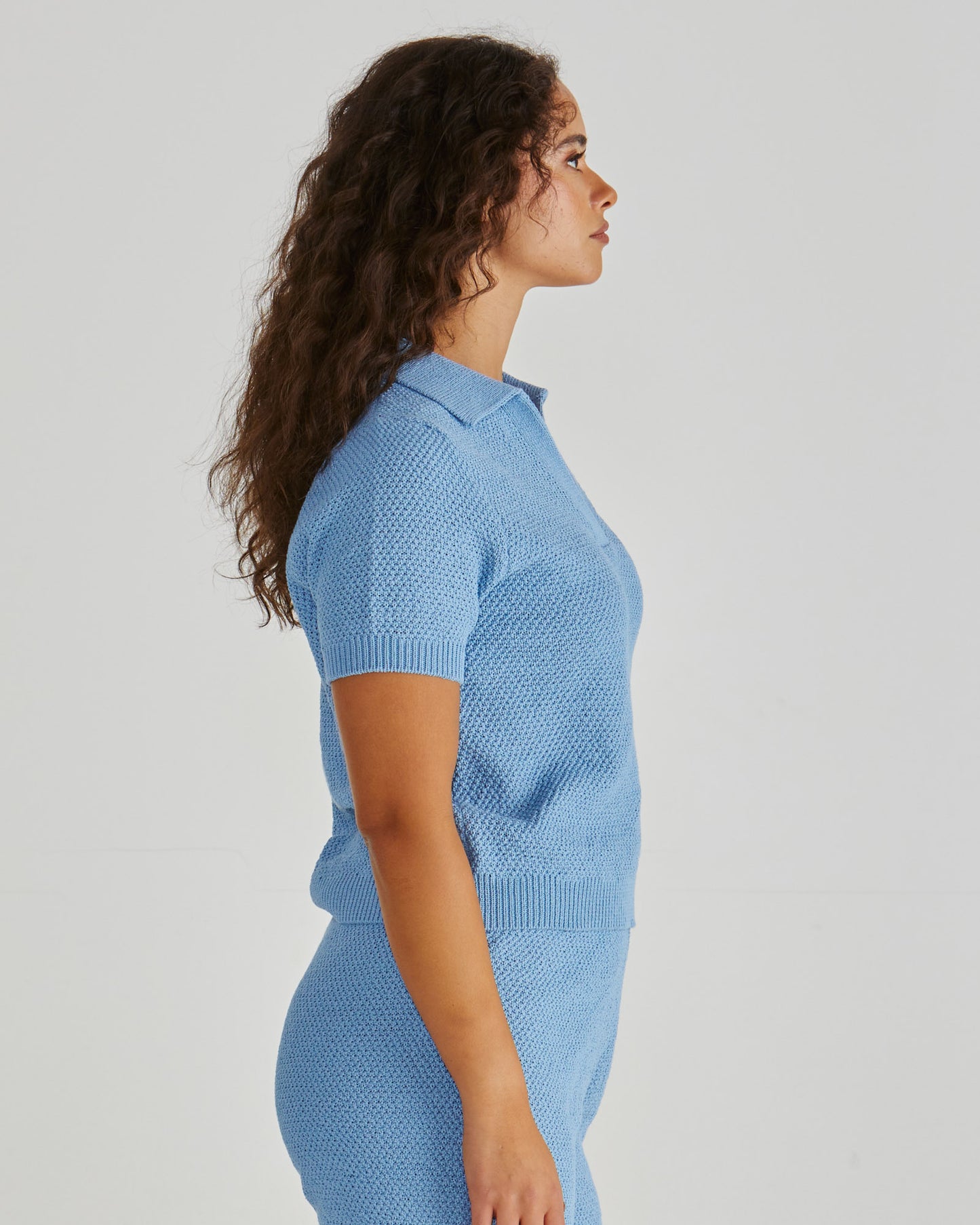 Side View of Lady wearing the SASS Aubrie Knit Polo in Blue. Available at Loloma Living, Tamborine Mountain - stockist of SASS and Betty Basics.