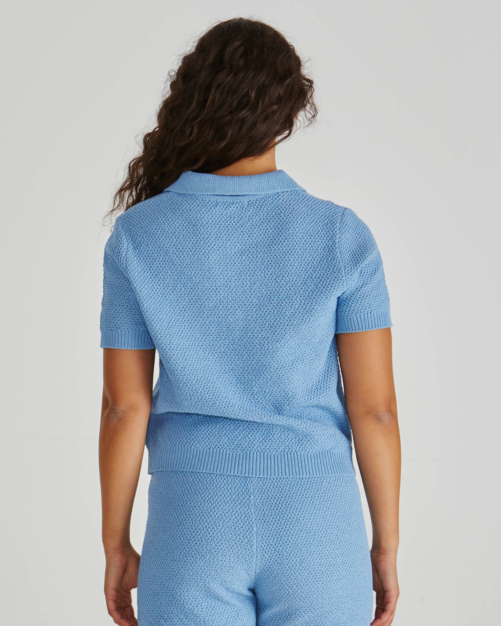 Back view of Lady wearing the SASS Aubrie Knit Polo in Blue. Available at Loloma Living, Tamborine Mountain - stockist of SASS and Betty Basics.