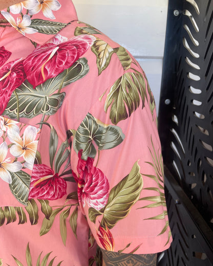 Man wearing island shirt pink tropical print showing a close up of the sleeve and collar. Available at Loloma Living Tamborine Mountain.