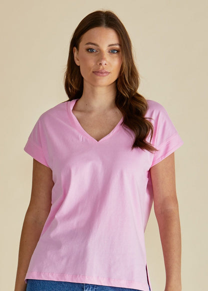 Woman wearing a pink t-shirt and blue jeans against a beige background betty basics pink tshirt stockist Loloma Living Tamborine Mountain