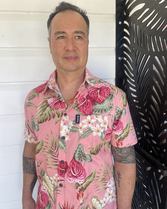 Man wearing an island shirt in pink tropical print. Made in Fiji Bula Shirt. Available at Loloma Living Tamborine Mountain.